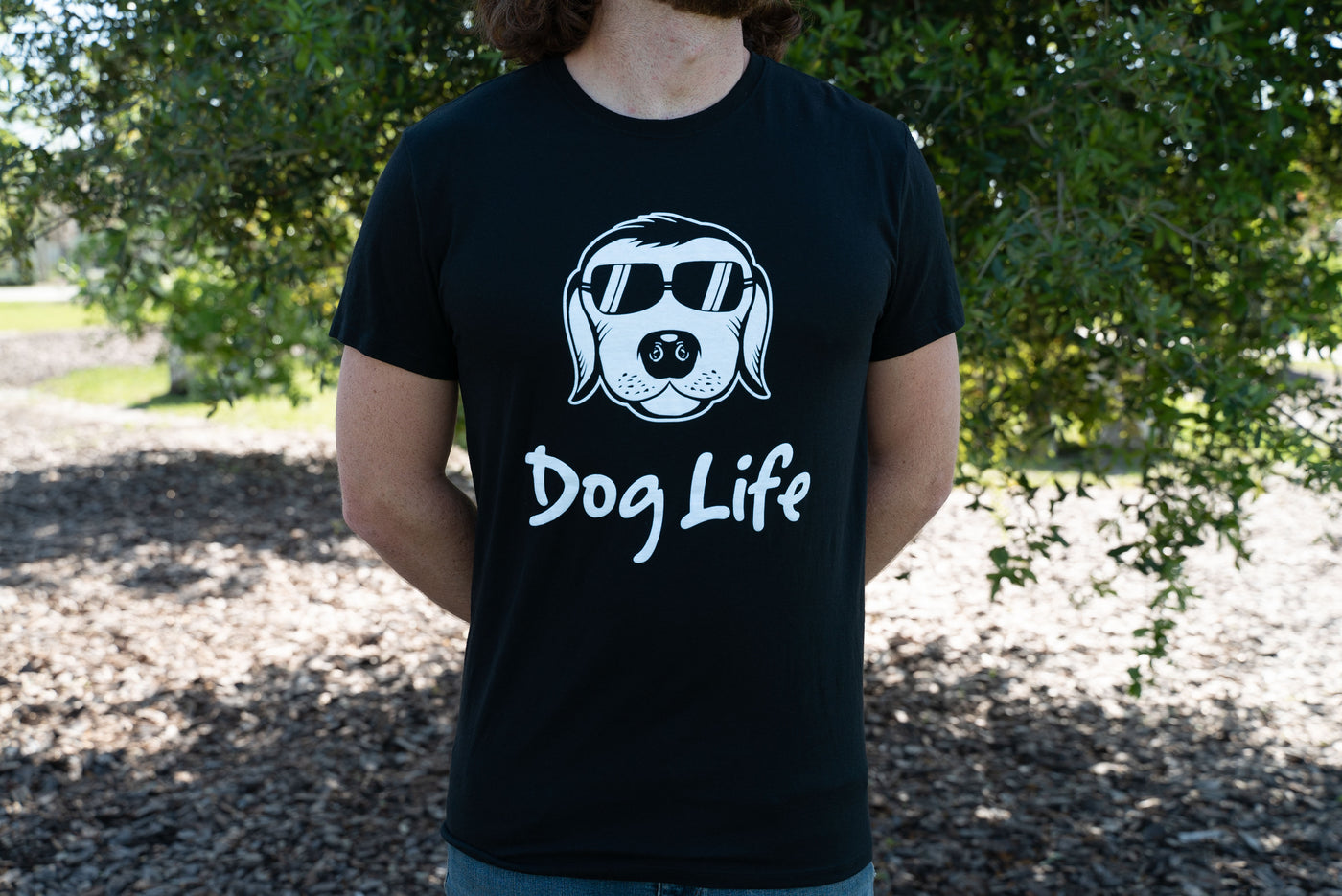 Black dog life tee shirt worn by man.  tee shirt is for sale by doglifebrand aka doglife