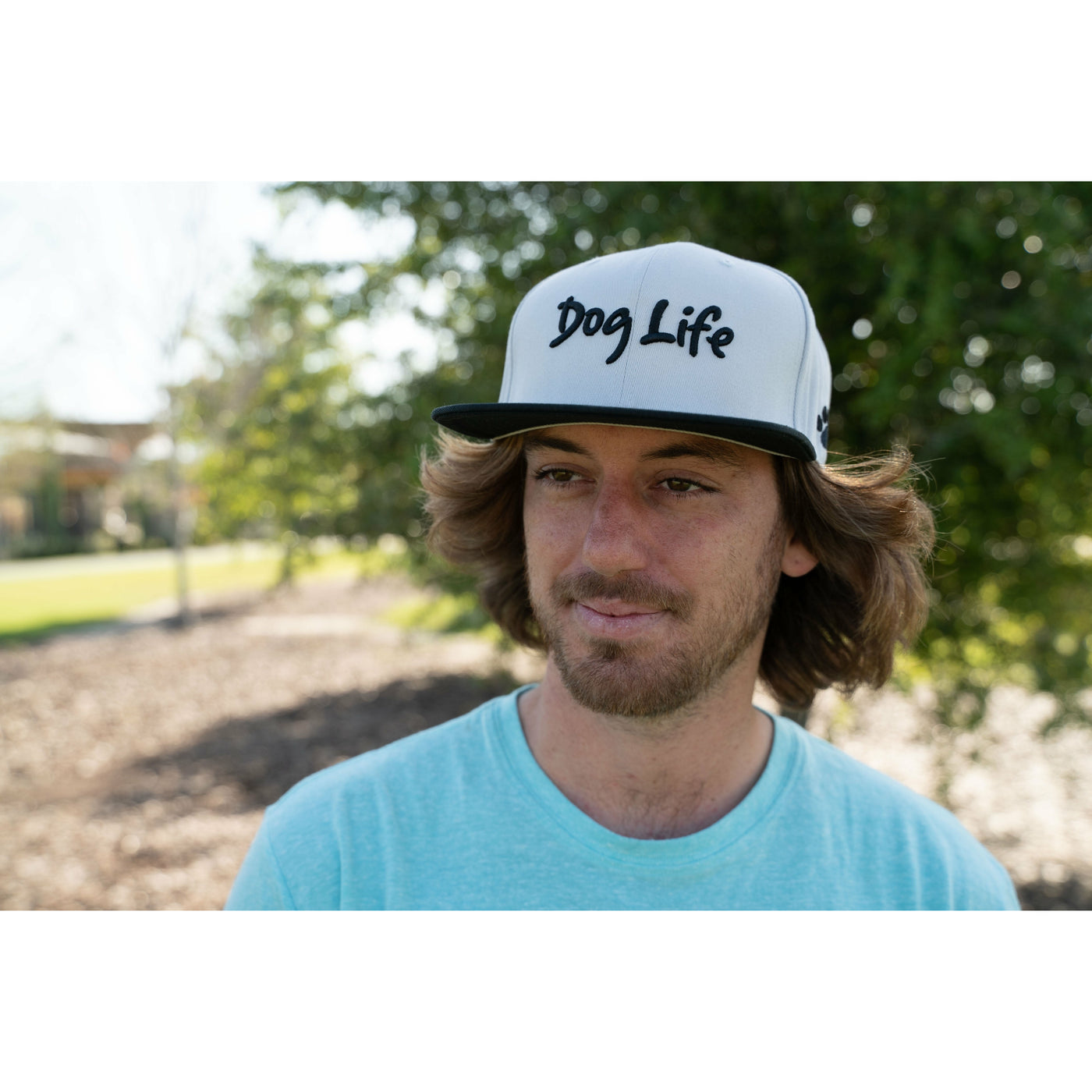 Young man wearing snap back Dog Life hat